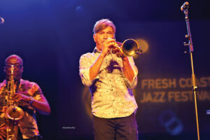 A man playing trombone on stage