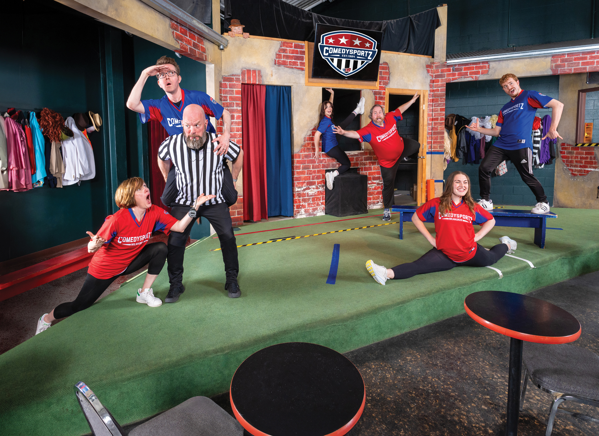 The Comedy Sportz team pose in actions on the stage