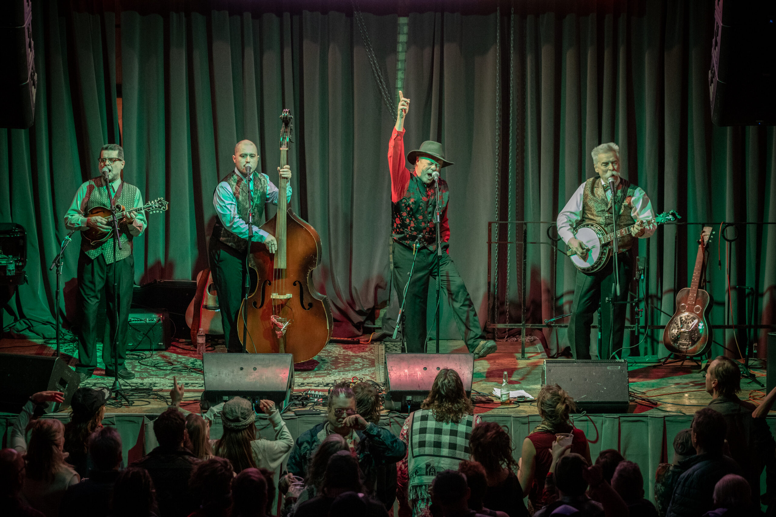 Art Stevenson & High Water perform with Stevenson's hand pointed upward at the Bluegrass Winter Heater at The Cooperage.