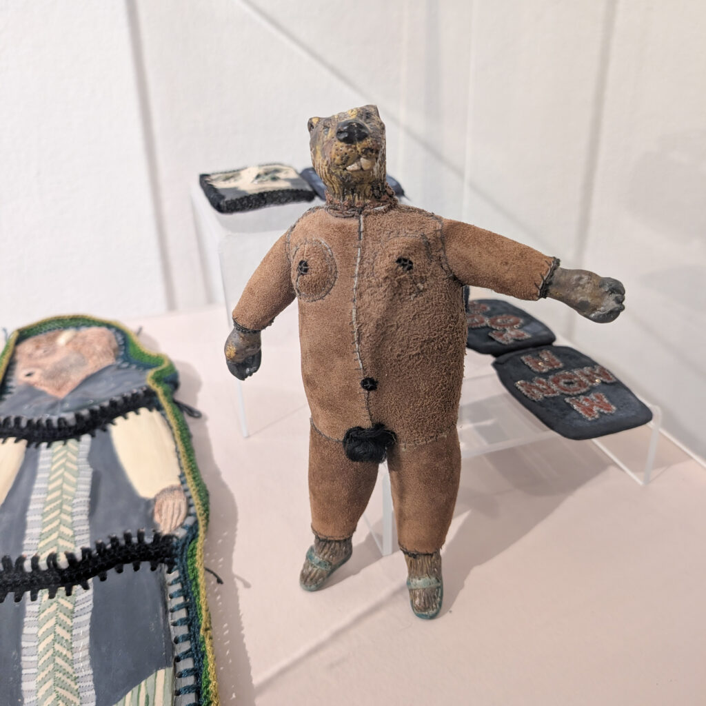 A figurine artwork of a naked person with a beaver head.