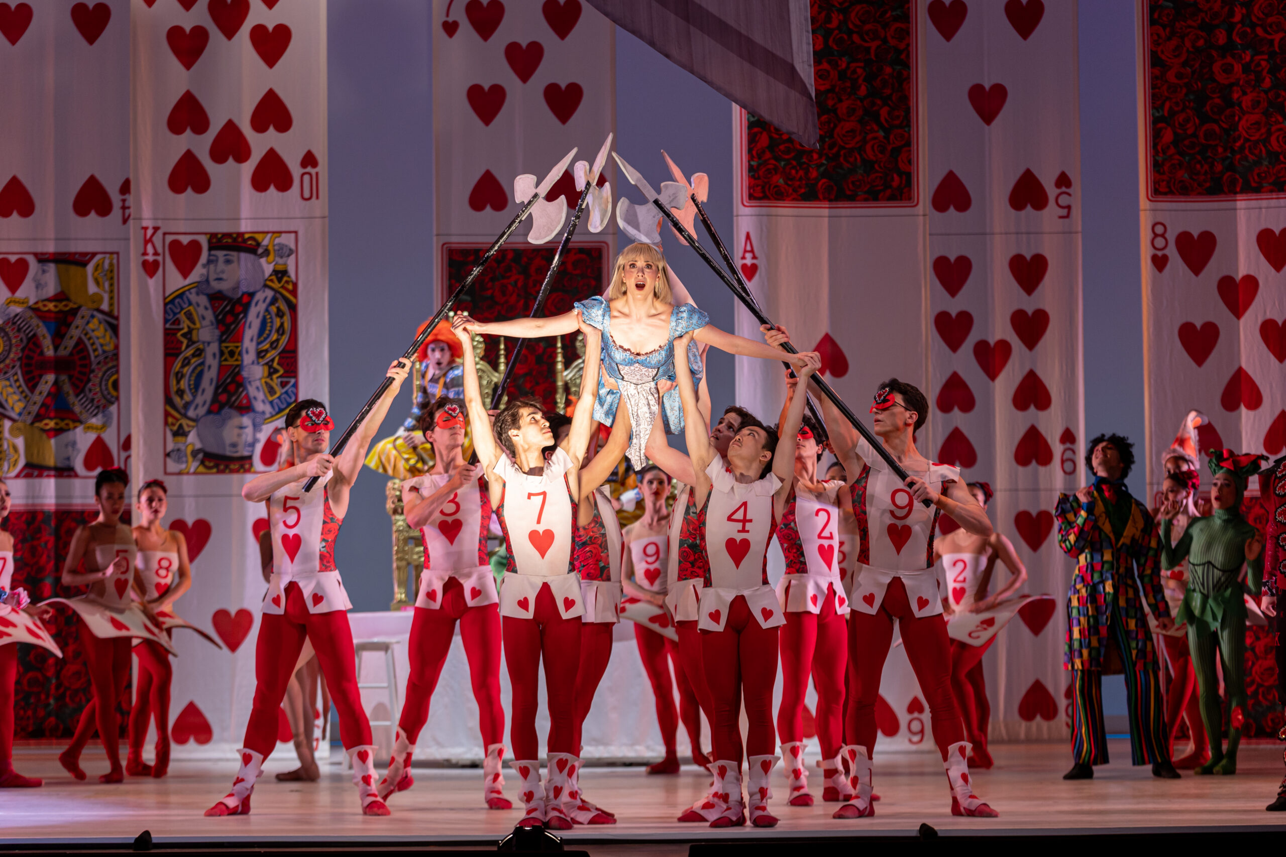 In a ballet production of "Alice (in wonderland)," Alice is apprehended by playing cards.
