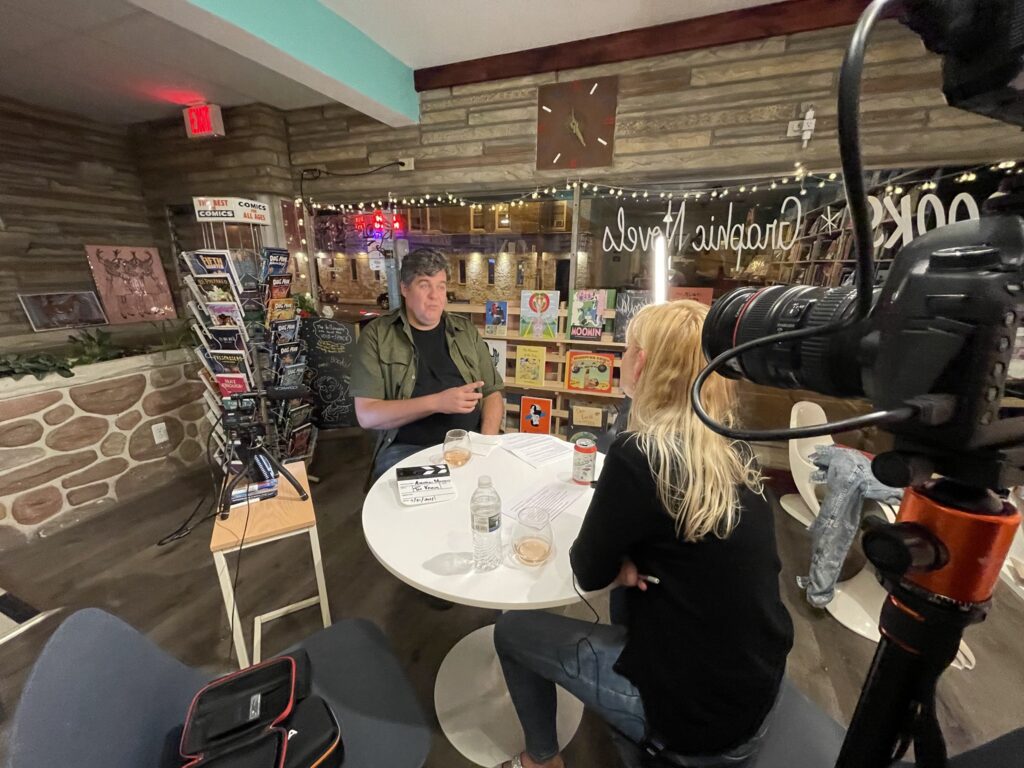 Tea Krulos being interviewed in a local book store.