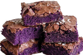 Milwaukee's Ube Craze is Here and Other Dining Tidbits A stack of square ube brownies featuring vibrant purple centers and shiny crackled tops.