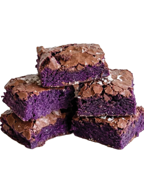 A stack of square ube brownies featuring vibrant purple centers and shiny crackled tops.