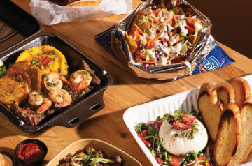 A spread of food on a wooden table.
