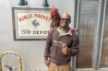 A man and a rooster posing for a photo.
