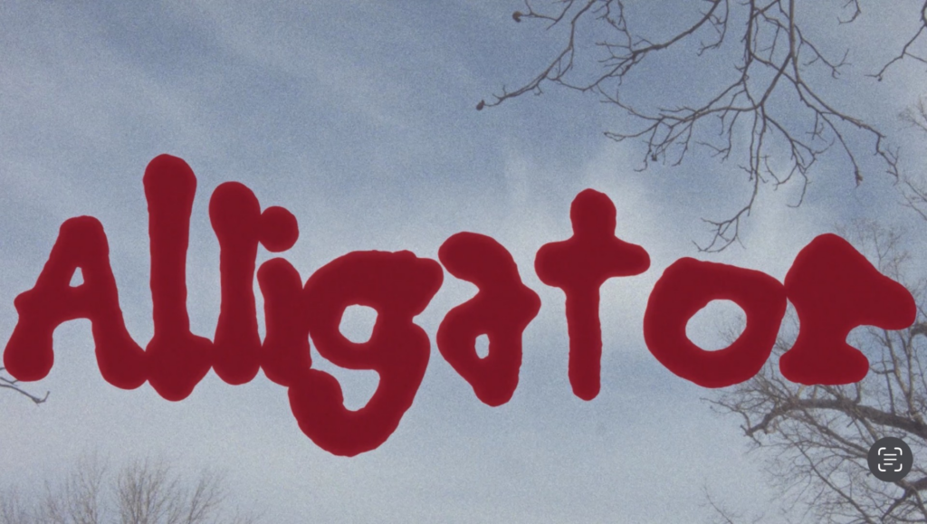 A movie title card with alligator in thick red text.