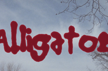 A movie title card with alligator in thick red text.
