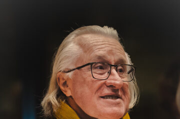 A portrait of Daniel Petry wearing a scarf.