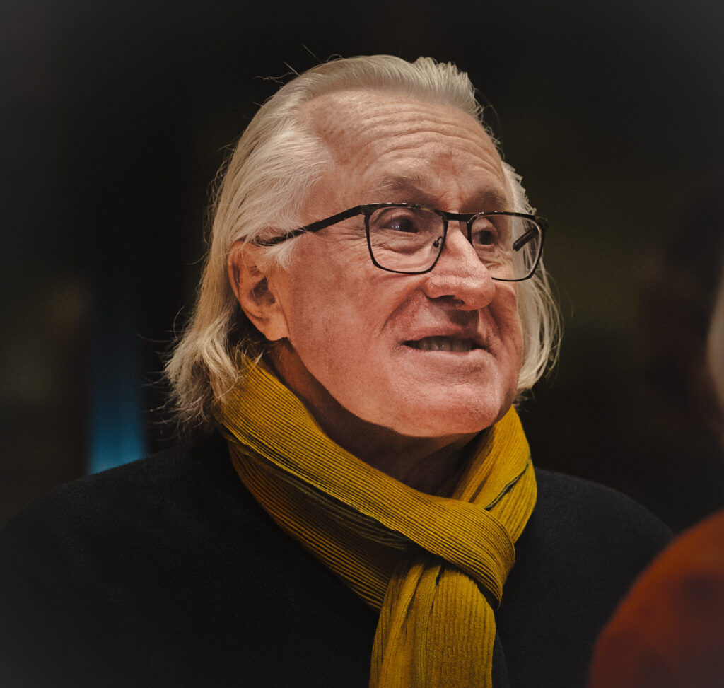 A portrait of Daniel Petry wearing a scarf.