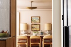 The dining room is swathed in Farrow and Ball’s Setting Plaster, a velvety pinkish hue. A Balinese dining table, sourced via now-closed Elements East, adds visual weight to the space, and a vintage rug offers a durable foundation underfoot. Photo by Kevin J. Miyazaki.