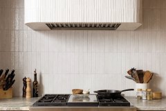 In the office, original walnut paneling adds an unmistakable richness, while the curtains, also original, invite softness and depth. The pendant light is original as well, pairing function with vintage charm. Photo by Kevin J. Miyazaki